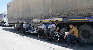 Şırnak'ta tır parkında bekleyen şoförler araçlarının gölgesinde serinliyor